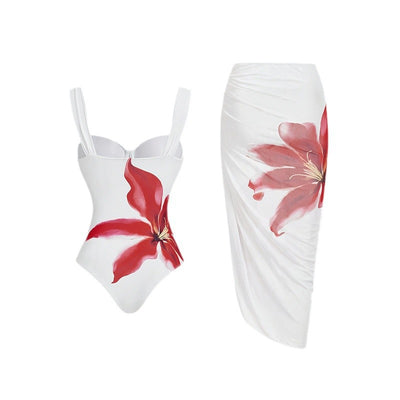 White one-piece swimsuit with red floral print and matching ruched sarong skirt for beach or resort wear. - Image 5
