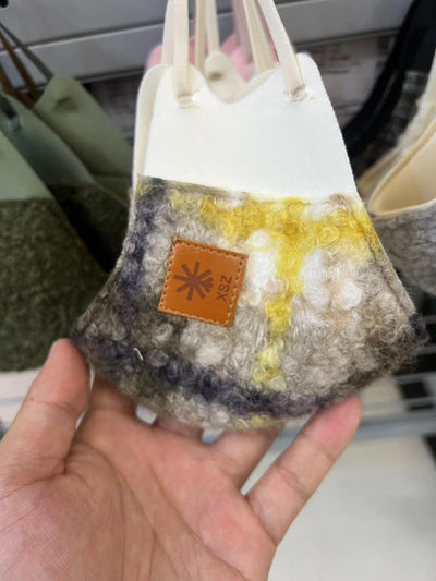 Beige curly plush warm mask with cream trim and a brown faux leather patch, held by a hand. - Image 6
