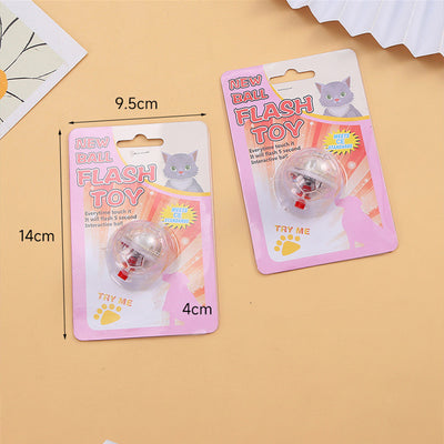 Transparent plastic pet toy ball with an internal bell and red flashing light, packaged on a pink card. - Image 5