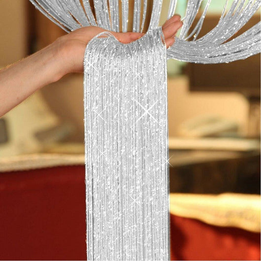 Hand holding a section of a silver shimmering string curtain with sparkling threads, ideal for door or room partition. - Image 2