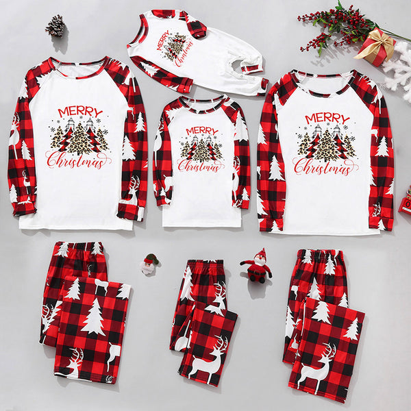 Matching family Christmas pajamas in red and black plaid with "Merry Christmas" text, tree, and reindeer prints.