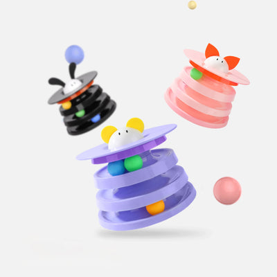 Brown tabby cat sniffing a black and orange multi-level rotating cat plate toy with colorful balls and bunny ears. - Image 4