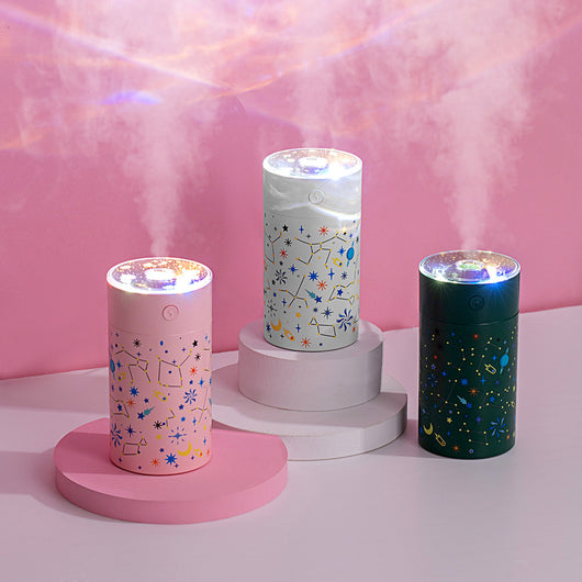 Dark green cylindrical humidifier with a clear top, featuring a colorful celestial pattern of stars, planets, and constellations. - Image 8