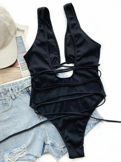 White ribbed one-piece swimsuit with deep V-neck, hollow cut-outs, and criss-cross tie straps. - Image 15