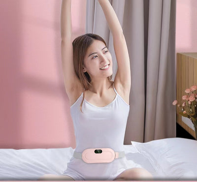 Pink electric stomach warming belt with lumbar support, digital display, and adjustable grey strap on a pink pedestal. - Image 6