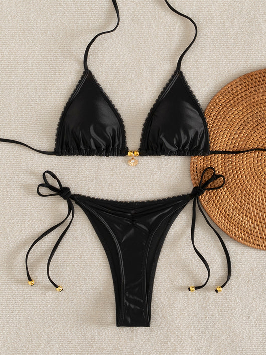 Black two-piece bikini swimsuit set with triangle top, shell pendant, and tie-side ruched bottoms with ruffled trim. - Image 17