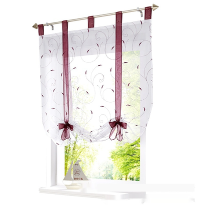 White sheer Roman window screen with red embroidered floral patterns and red ribbon ties, hanging from a silver rod. - Image 15