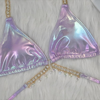 Iridescent purple and pink two-piece bikini with gold-toned crystal embellishments on a white faux fur background. - Image 11
