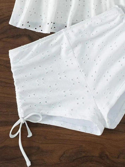 Light green two-piece bikini with a scalloped shell-shaped top, eyelet details, peplum hem, and matching shorts with side ties. - Image 30