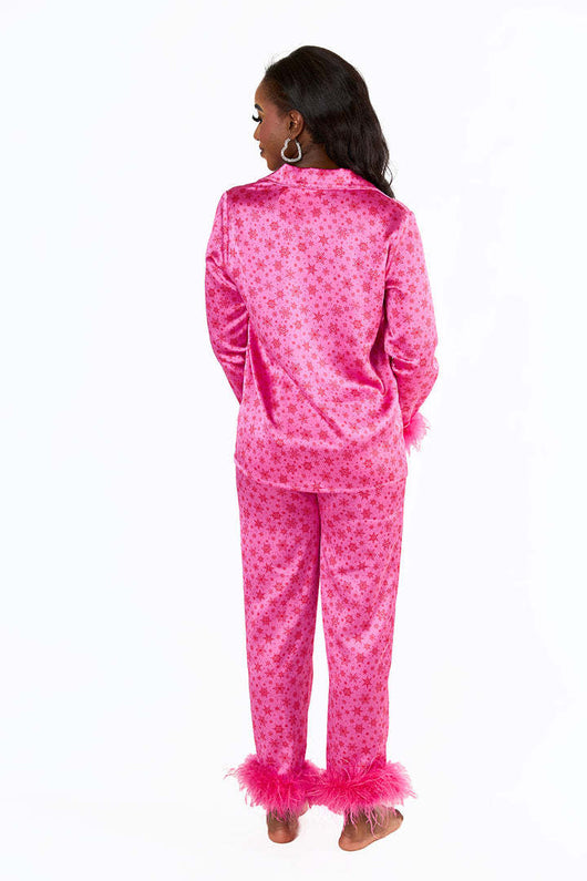 Young girl in a leopard print pajama set with black feather trim on the cuffs and ankles, wearing a pink glitter headband. - Image 16