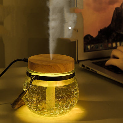 Desktop humidifier with a clear, crackled glass base, white lid, and a brown rope handle. - Image 10