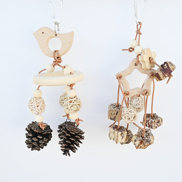 Natural bird toy with a wooden bird, ring, beads, rattan balls, and pinecones, hanging from a metal clip.