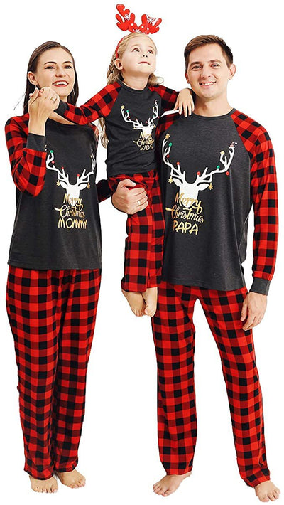 Woman wearing a Christmas pajama set with a dark gray 'Merry Christmas MOMMY' reindeer top and red and black plaid pants. - Image 4