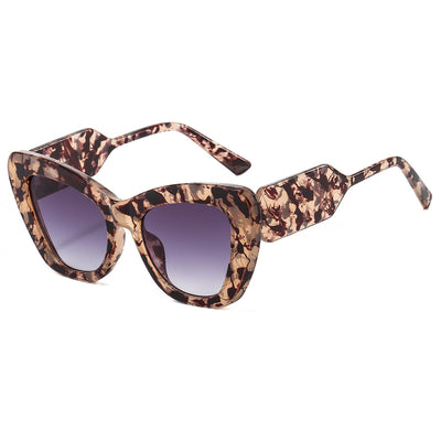 Pink cat-eye sunglasses with green temples and brown to pink gradient lenses on a white background. - Image 8