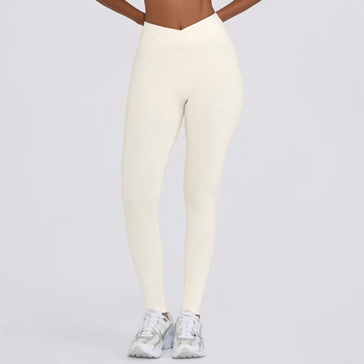 Light pink halter neck sports bra and high-waisted leggings workout set on a model. - Image 29