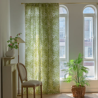 Green curtain with white leafy botanical pattern and cream tassels, hanging in a window with natural light. - Image 4