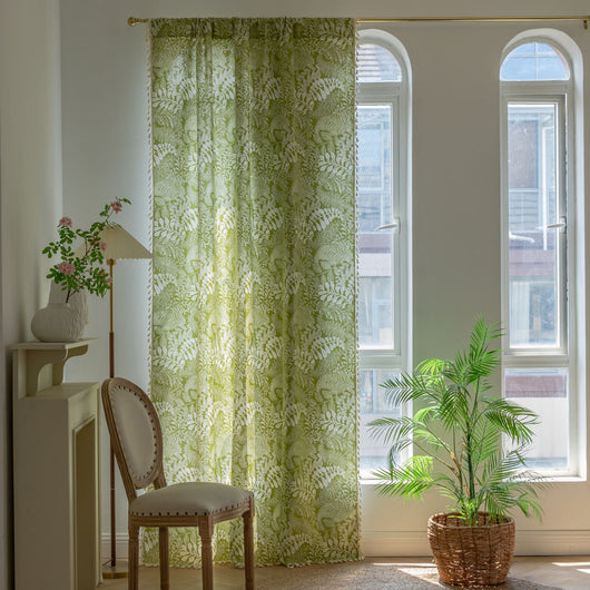 Green curtain with white leafy botanical pattern and cream tassels, hanging in a window with natural light. - Image 4