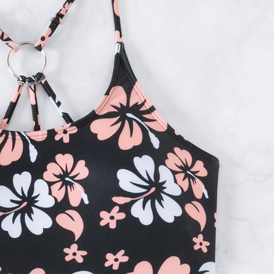 Women's two-piece swimsuit featuring a black halter crop top with pink and white floral print and solid black swim shorts. - Image 3