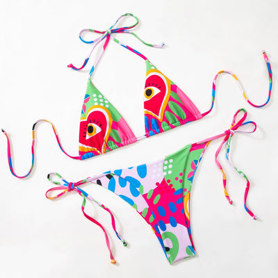 Women's vibrant abstract eye print bikini with triangle top and tie-side bottoms, featuring pink, green, and blue. - Image 6