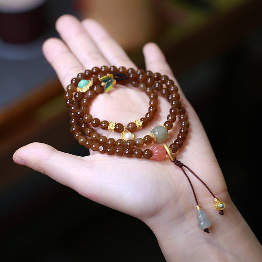 Pulsera de Tres Aros con Perla de Calabaza y Mariposa