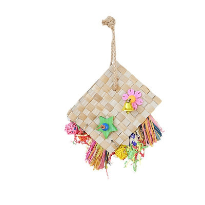 Colorful parrot foraging toy with woven palm leaf, a bell, wooden star, and shredded paper, hanging against a white wall. - Image 4