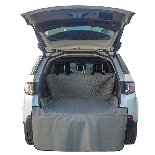 Gray quilted pet car mat installed in the trunk of a white SUV, protecting the cargo area and bumper. - Image 6