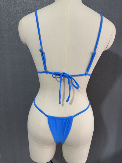 White three-point bikini with gold chain straps on a mannequin, featuring a triangle top and thong bottom. - Image 39