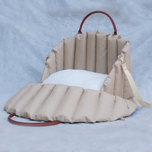 Light khaki quilted portable pet carrier with brown handles and a cream shoulder strap for car travel. - Image 4