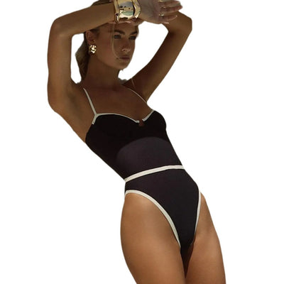 Black one-piece swimsuit with white trim, thin straps, sweetheart neckline, and high-cut leg on a model. - Image 5
