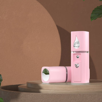 White egg-shaped portable facial humidifier with a pink cartoon rabbit inside a clear dome, gold nozzle and button. - Image 11