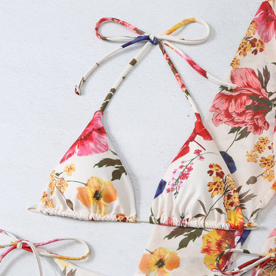 Milky white floral print three-piece swimsuit with triangle bikini top, v-cut bottom, and sheer long-sleeve cover-up. - Image 17