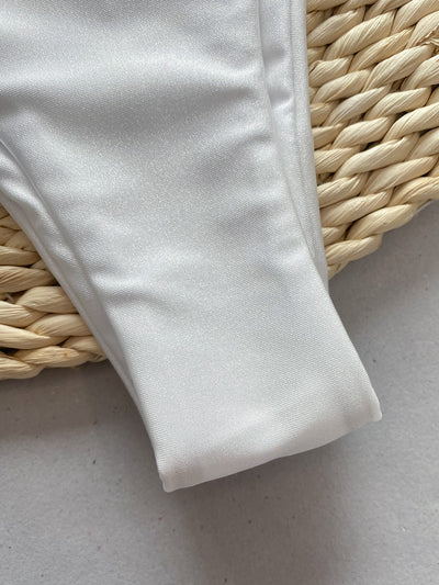 Rust underwire bikini set with ruched top and high-cut bottom, displayed on a woven mat. - Image 15