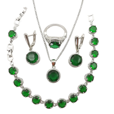Four-piece silver-tone jewelry set with round green gemstones, including a necklace, bracelet, ring, and dangle earrings. - Image 2