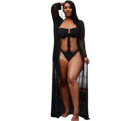 Woman in black mesh see-through long sleeve swimsuit cape over a matching cutout bandeau swimsuit with hot drilling. - Image 15