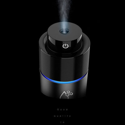 Silver-gray car humidifier and air purifier with a black top, emitting mist and glowing with a blue LED light. - Image 11