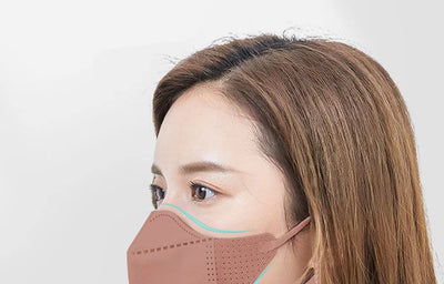 Peach disposable 3-layer face mask with perforated details worn by a person, offering comfortable daily protection. - Image 34