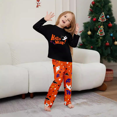 Family of four wearing matching black and orange Halloween long-sleeve pajamas with ghost and bat prints. - Image 4