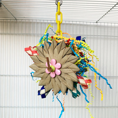 Colorful parrot chew toy made from natural fibers, featuring a woven ball, leaf-like accents, a bell, and a carabiner clip. - Image 9