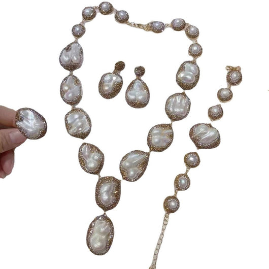 Baroque pearl necklace, ring, earrings, and bracelet set with gold-toned settings and sparkling accents. - Image 2