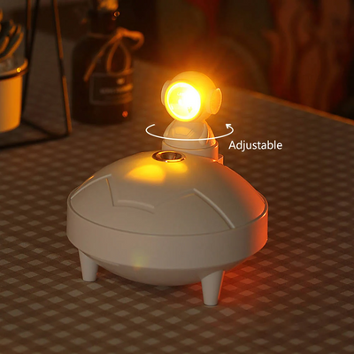 White astronaut sunset lamp humidifier with a 360-degree rotating head and two spray modes, on a light background. - Image 7