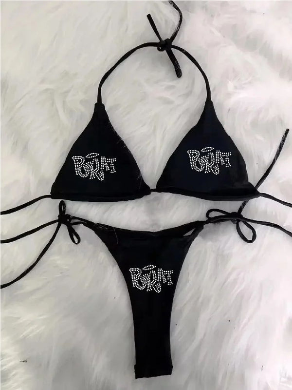 Black halter bikini with rhinestone 'BRAT' lettering on triangle top and tie-side bottom, displayed on white faux fur. - Image 5